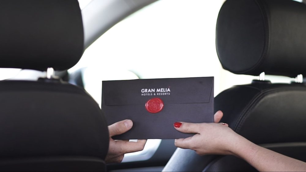 Invitation card for Gran Meliá de Isora luxury resort, part of a PuraVideos film highlighting the infinity pool, restaurants, and elegant rooms of this Tenerife destination