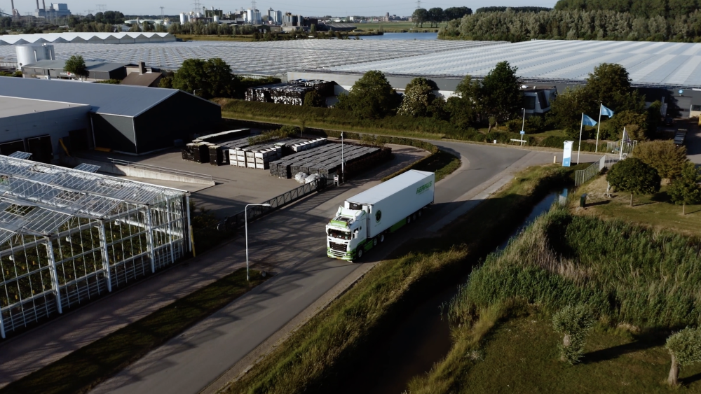Drone shot of a Hermus International truck transporting goods across Europe, featured in a PuraVideos brand film showcasing reliable logistics services